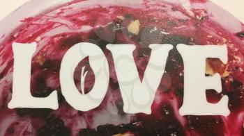 text love on red cherry pie syrup close up