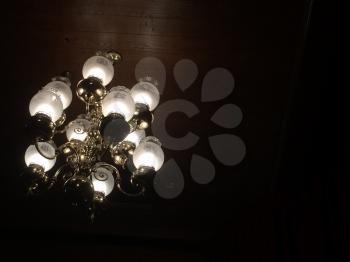 old fashoned vintage chandelierlit up on dark background