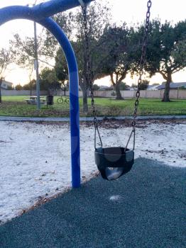 Empty swing at playground for baby and toddler saftey seat