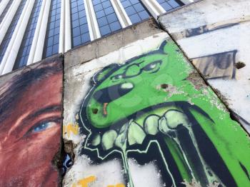Urban street art with green dog barking angry and mean