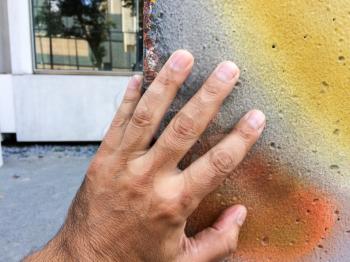 Human Hand on concrete Berlin wall spray painted urban street art