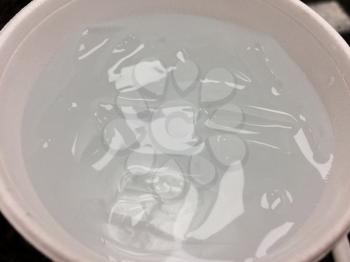 Cup of water with ice on restaurant table