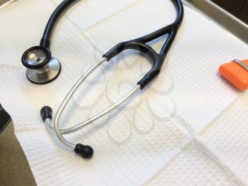 Stethoscope rubber reflex hammer onwhite tray doctors office equipment