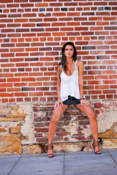 Young female model brunette pretty spring summer top with brick red background