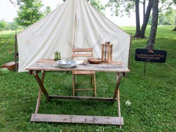 american civil war reenactment scene with white tent