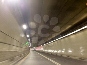 fast moving blurred car tunnel from driver view underground with light