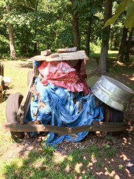 rusty antique ford car in backyard with spoked wheels junkyard