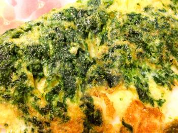 spinach quiche lorraine green yellow and crispy golden brown plate
