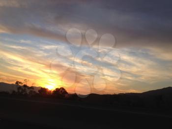 amazing sunset sunrise over mountain while freeway driving