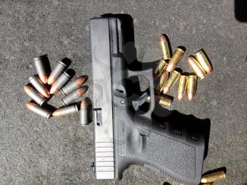 Bullets 9mm 40 caliber close up with Glock handgun firearm pistol