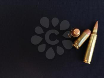 Bullets rifle handgun pistol firearm closeup on black backgound text space design element business card sign