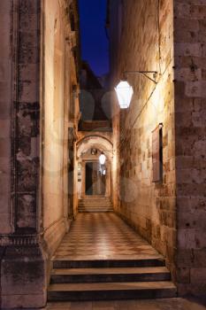 Dubrovnik, Croatia - 21 February 2019: Old Pharmacy at Franciscan Monastery entrance by night