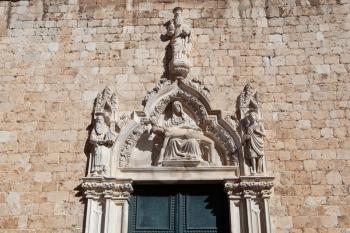 Dubrovnik, Croatia - 21 February 2019: Franciscan Church and Monastery portal sculptures showing Virgin Maria and Jesus