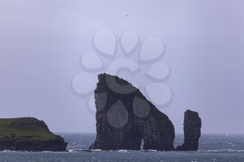 Drangarnir sea stacks seen across the Sorvagsfjordur from Bour village, Faroe Islands