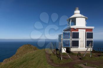 Kallur Lighthouse on a bright day with blue sky, Kalsoy, Faroe Islands