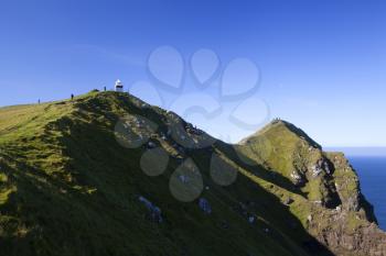 Kallur lighthouse hiking area on a bright sunny day with blue sky