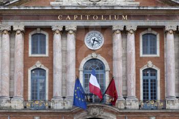 Capitole de Toulouse close-up with flags and clock