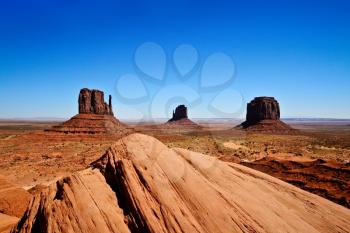 Monument Valley is a region of the Colorado Plateau characterized by a cluster of vast sandstone buttes. It is located on the Arizona Utah border, near the Four Corners area. The valley lies within the range of the Navajo Nation Reservation.