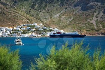 Yatchs and ships in Kamares village with turquoise water and mountain in Sifnos In Greece