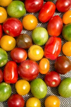 Various colored organics tomatoes cuts