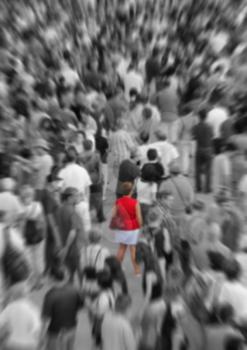 Blur background showing woman in red in a middle of a crowd in black and white
