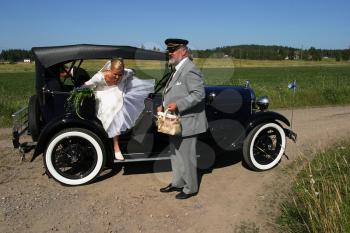 Royalty Free Photo of a Bride Getting Out of a Car