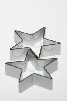 Two silver star cookie cutters.