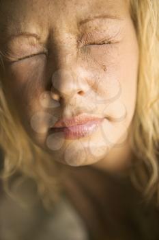Royalty Free Photo of a Blond Woman With Closed Squinting Eyes