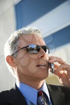 Royalty Free Photo of a Man in a Suit Talking on a Cellphone in an Urban Setting