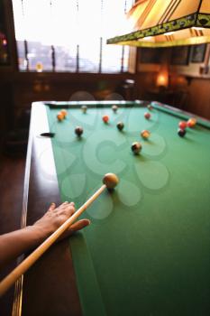 Royalty Free Photo of a Woman's Hand Preparing to Hit a Pool Ball While Playing Billiards