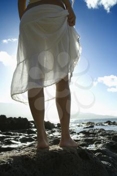 Royalty Free Photo of a Woman Standing on a Rocky Beach in Maui Hawaii