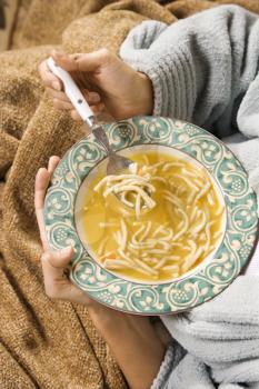 Royalty Free Photo of a Woman Holding a Bowl of Soup