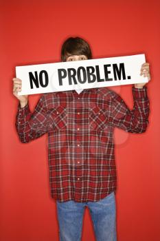 Royalty Free Photo of a Teen Boy Holding a No Problem Sign Under His Eyes