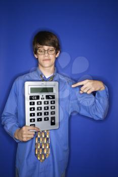 Royalty Free Photo of a Teenage Boy Holding and Pointing to a Giant Calculator