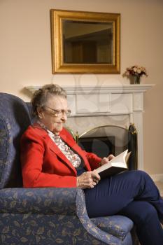 Royalty Free Photo of an Elderly Woman Reading a Book at a Retirement Community Center