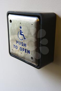 Royalty Free Photo of a Metal Door Entrance Button for a Physically Challenged or Handicapped People
