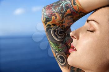 Royalty Free Photo of a Tattooed Woman With Pacific Ocean in the Background in Maui, Hawaii, USA