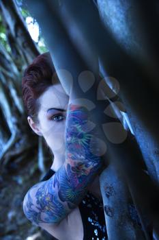 Royalty Free Photo of a Tattooed Woman With a Banyan Tree in Maui, Hawaii, USA