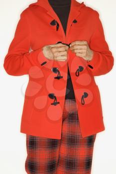 Royalty Free Photo of a Woman Buttoning a Coat