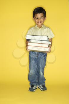 Royalty Free Photo of a Boy Holding a Stack of Books