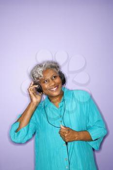 Royalty Free Photo of an Older Woman Listening to Music