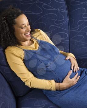 Royalty Free Photo of a Portrait of Pregnant Woman With Her Hands on Her Stomach