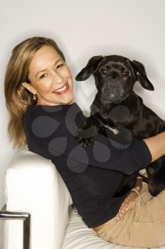 Royalty Free Photo of a Woman Holding a Black Puppy