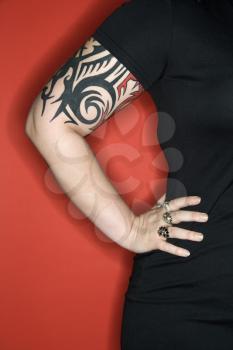 Royalty Free Photo of a Tattooed Woman With Her Hand on Her Hip