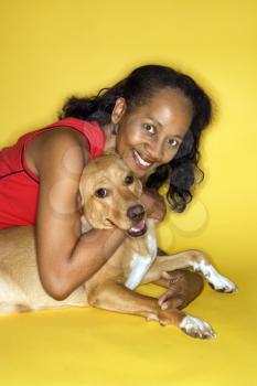 Royalty Free Photo of a Female Hugging a Dog