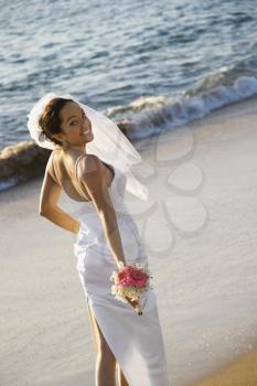 Royalty Free Photo of a Bride Standing on a Beach