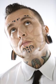 Royalty Free Photo of a Man With Tattoos and Piercings
