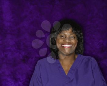 Royalty Free Photo of a Woman Smiling Wearing Scrubs