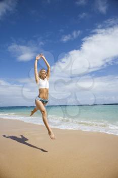 Royalty Free Photo of a Woman Jumping on the Beach