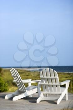 Royalty Free Photo of Adirondack Chairs on a Deck Looking Towards the Beach on Bald Head Island, North Carolina